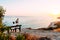 Happy couple at sunset. Man and woman at dawn. Couple sitting on a bench by the sea. Couple in love kissing by the sea. Man and