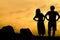 Happy couple on Sunset rock - Silhouette