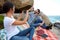 Happy couple taking pictures during a relaxed picnic on the rock