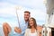 Happy couple taking a selfie after engagement proposal at sailing boat, relaxing on a yacht at the sea.