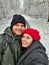 happy couple taking selfie in snowed forest