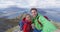 Happy couple taking selfie video on top of mountain living healthy lifestyle