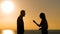 Happy couple talking at sunset on the beach