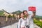 Happy couple tourists taking selfie picture at Great wall of china, top worldwide tourist destination. Young multiracial