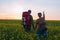 Happy couple of travelers in a field of yellow flowers