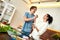 Happy couple, vegetarians preparing healthy meal, sandwhich, salad in the kitchen together. Young woman and man feeding