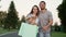 Happy couple walking on street after shopping. Handsome man hugging happy woman