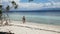 Happy couple walking on a tropical beach