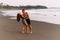 A happy couple walks along the beach at sunset. Lovers on the coast. Man and woman are resting on the sea.