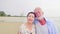 Happy couples standing together on the beach