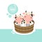 Happy cow and baby in the wood bath tub.