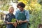 Happy coworkers holding root vegetables