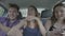 Happy crazy friends dancing and laughing in the back of driving taxi car while they hanging out -