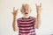 Happy and crazy senior old man with rock`n roll hand sign - alternative mature caucasian portait people have fun -youthful retire