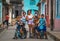 Happy Cuban children portrait in poor colorful colonial street alley with smile face, in old city, Cuba, America.