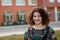 Happy curvy girl with curly hair in the street