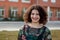 Happy curvy girl with curly hair in the street