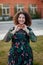 Happy curvy girl with curly hair in the street