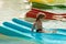 Happy cute baby boy slides from blue waterslide