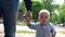 Happy cute baby with father walking in park