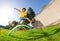 Happy cute boy jump over barriers on playground