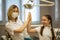 Happy cute child girl give high five to woman dentist in dental room.