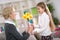 Happy cute girl giving flower her grandma