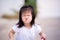 Happy cute girl sitting riding bicycle. Child looks at the camera and makes a funny cheeky monkey face.