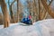 Happy cute little boy and girl slide in winter snow