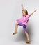 Happy cute little girl in dress smiling and walking over white background