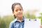 Happy cute little girl holding clipboard checklist with grass flowers in summer day, education concepts