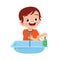 happy cute little kid boy wash hand in sink