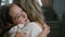 Happy cute little kid girl hugging foster care parent mother with eyes closed