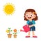 happy cute little kid girl watering flower