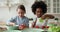 Happy cute little mixed race children chopping fresh vegetables.