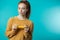 Happy cute redhaired young woman posing with yellow dumbbell