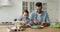 Happy cute small daughter cooking with father looking at camera