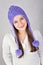 Happy cute young woman wearing purple beanie hat