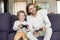 Happy dad having fun laughing playing video games with son