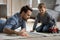 Happy dad and son wheeling toy cars on heat floor