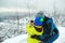 Happy dad and son at winter forest. Kid looking to monocular. Family winter holidays