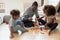 Happy daddy and two engaged preschooler kids building tower