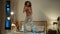 Happy dancing African American ethnic girl young joyful woman teenager jumping on bed in home evening bedroom night