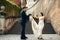 The happy dancing newlyweds on the street in Prague. Horizontal close-up view.