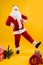 Happy dancing Santa Claus with hands on his waist extending leg