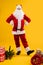 Happy dancing Santa Claus with hands on his waist, leg on heel