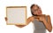 Happy dark skinned woman holding and pointing on empty whiteboard