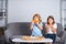 Happy daughter and son eating pizza. Children kids enjoy and having fun with lunch together at home. Two young children