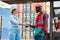 Happy dealing shaking hands two businesswoman and engineer working checking loading Containers box from Cargo freight ship for