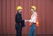 Happy dealing shaking hands two foreman man & woman worker working checking at Container cargo harbor to loading containers. Dock